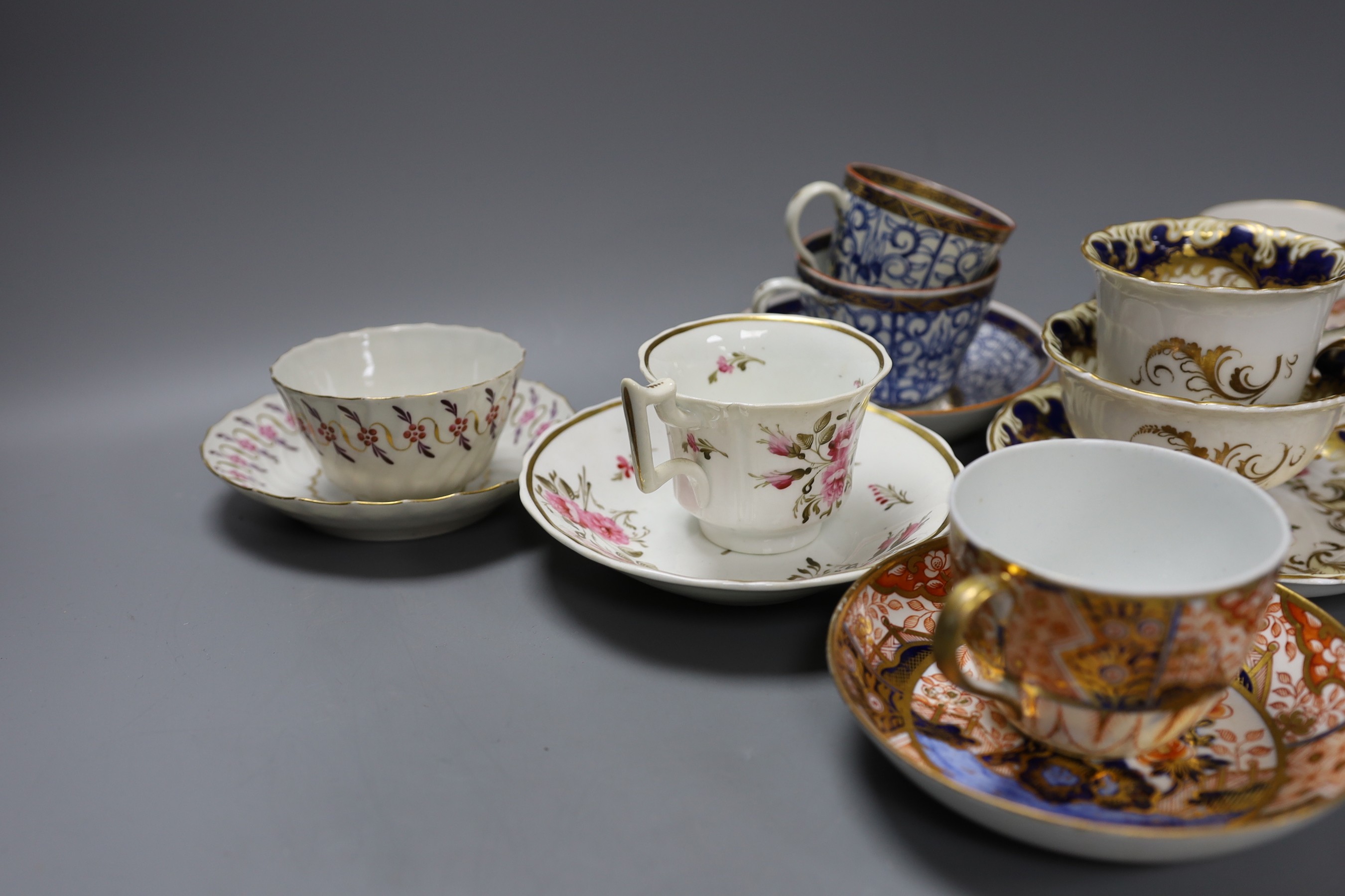 A Spode Imari pattern coffee can and saucer, a Coalport Imari cup and saucer, a Coalport style floral trio, a Worcester Royal Lily trio, a Flight teabowl and saucer and an English rose painted cup and saucer